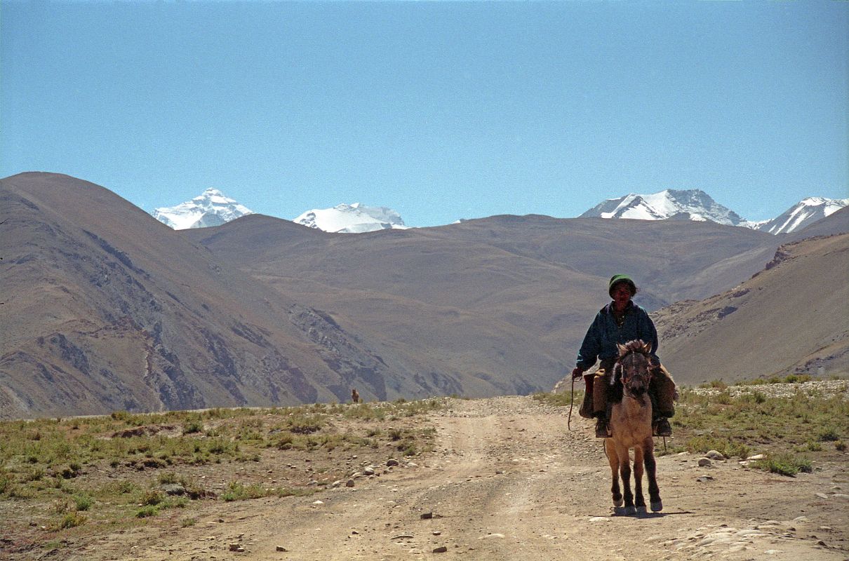 15 Local Villager Rides On A Horse By Our Lunch Spot With Everest North Face Poking Above Hill